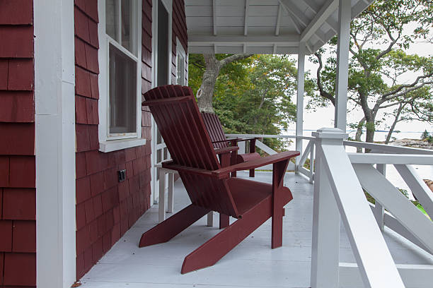 istock Porch with red Adirondack chairs 486725755