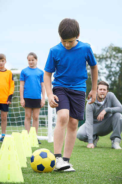 istock Coach Leading Outdoor Soccer Training Session 486725956
