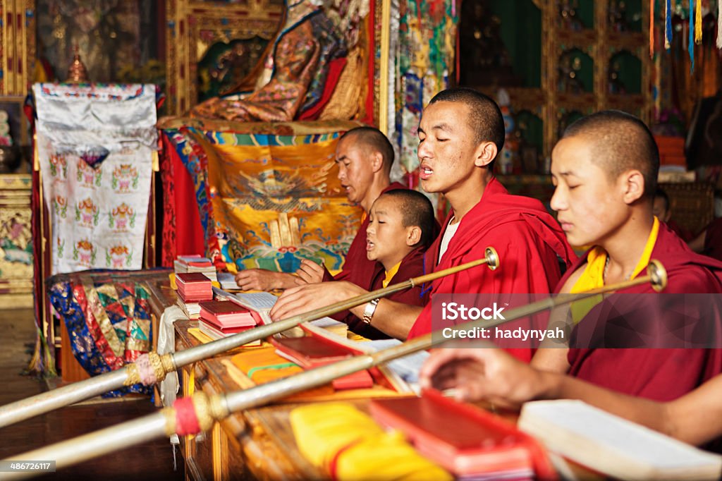 Tibetan monks praying during puja In Buddhism, puja are expressions of "honour, worship and devotional attention Acts of puja include bowing, making offerings and chanting. Tibet Stock Photo