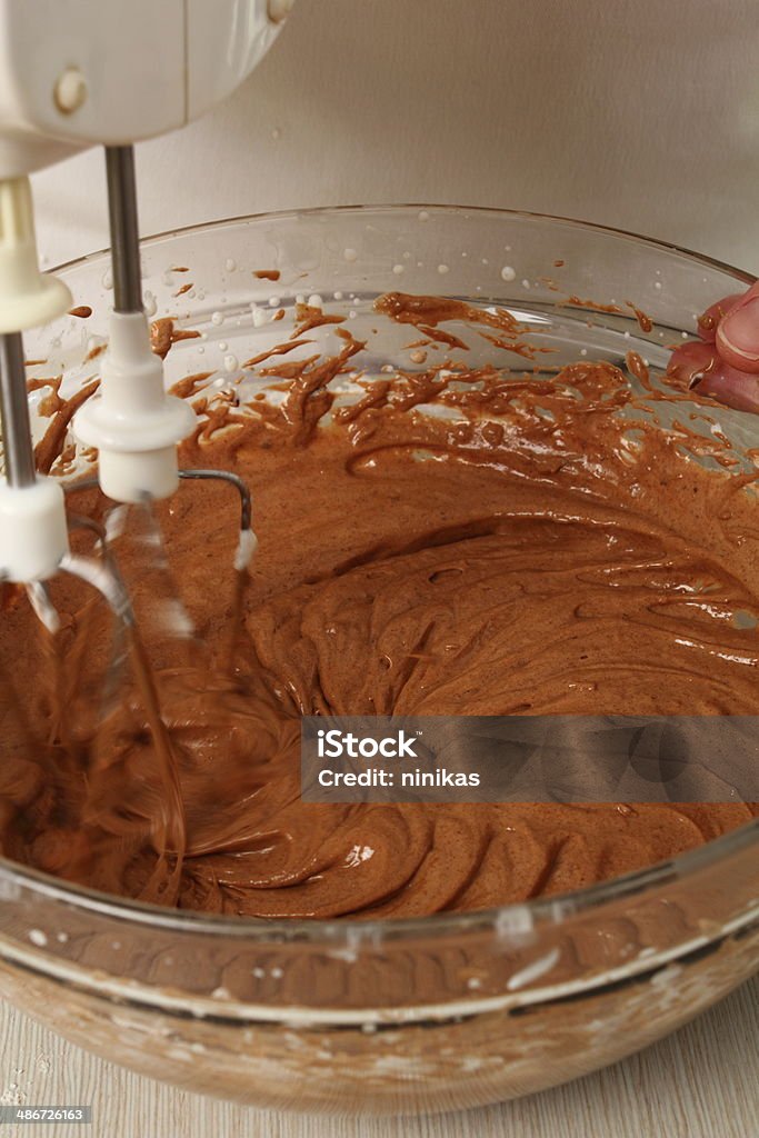 Making Chocolate Hazelnut Meringue Cake Making filling. Add chocolate mixture into whipped cream until just combined. Making Chocolate Hazelnut Meringue Cake Activity Stock Photo