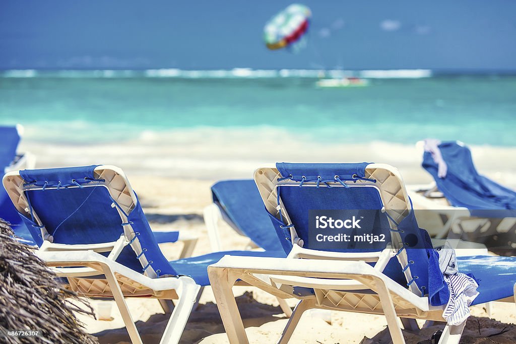 Caribbean Beach With Turquoise Water Tourist Resort on Caribbean Beach With Turquoise Water. Armchair Stock Photo