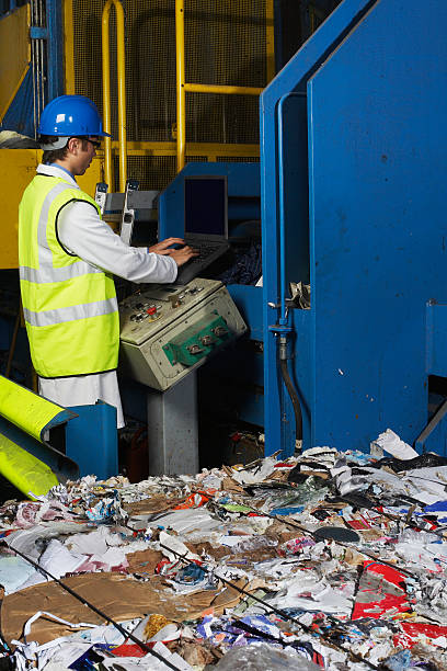 istock Worker Operating Conveyor Belt In Recycling Factory 486729787
