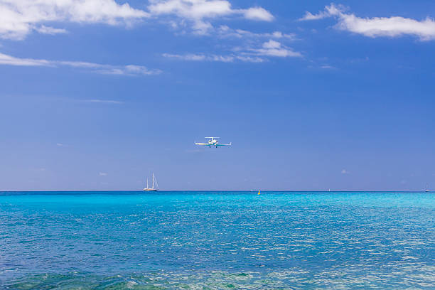 Airplane landing Over Caribbean Sea stock photo