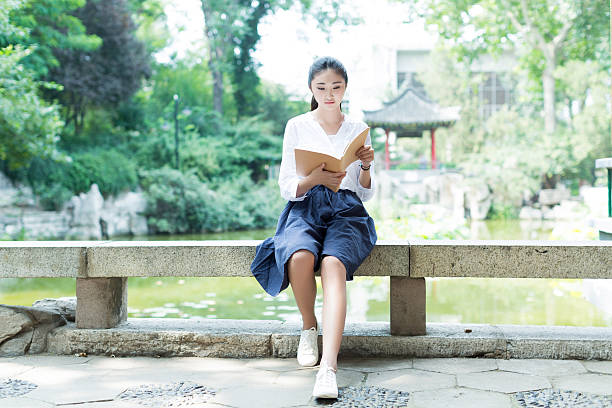 istock girl reading in the park 486734600