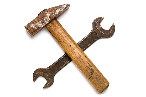 Crossed old hammer and wrench stock photo