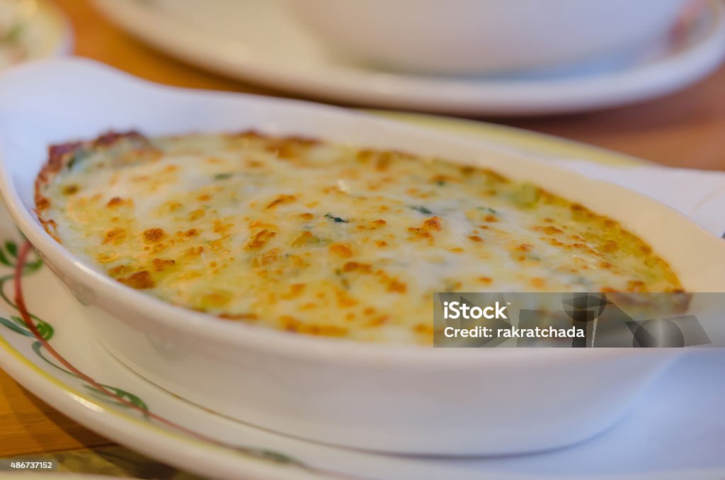 Baked spinach with cheese close up Baked spinach with cheese in white bowl 2015 Stock Photo