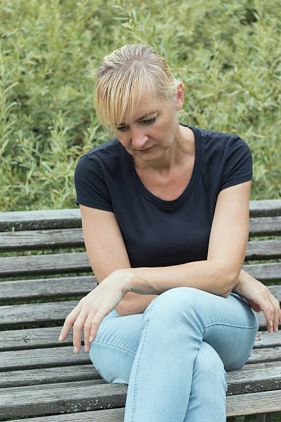 istock Frustrated blonde woman is sitting on the bench. 486739512