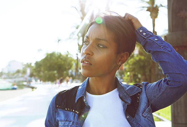 istock Young black woman posing with hand in hair 486741036