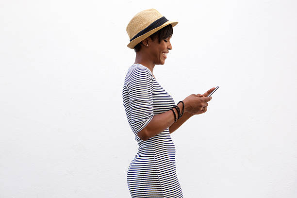 istock Cheerful young woman walking and texting 486741622