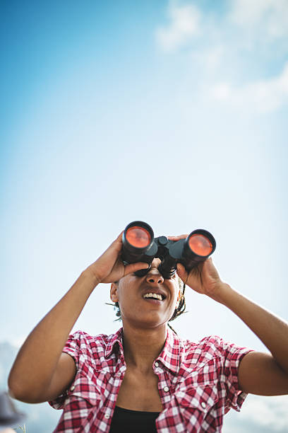 istock woman with binocular on top of mountain 486743563