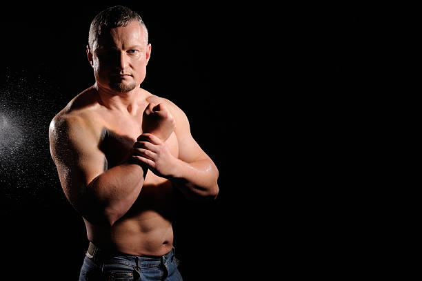 istock Muscular male posing on black background 486743665
