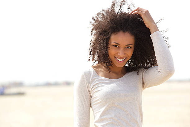 Close up portrait of a confident young woman smiling outdoors