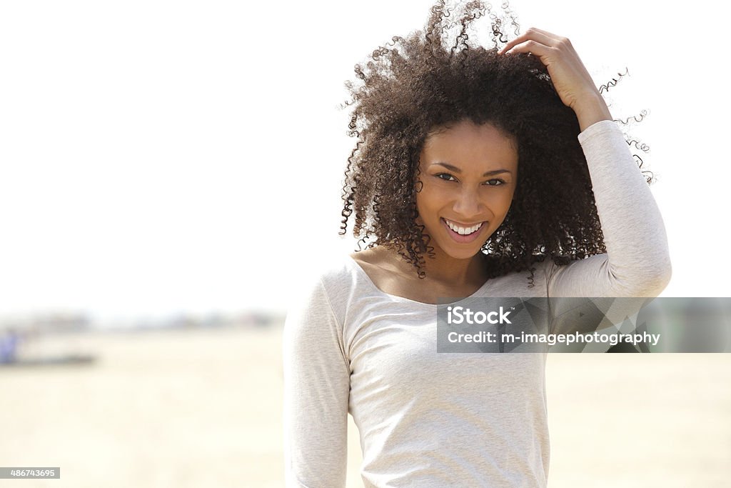 Confident young woman smiling outdoors Close up portrait of a confident young woman smiling outdoors Beach Stock Photo