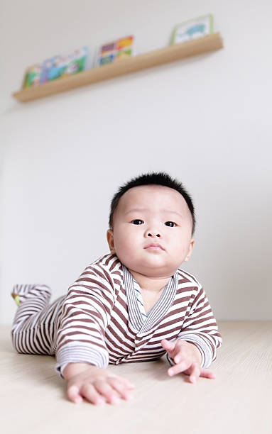 istock Cute Baby crawling on living room floor 486745243