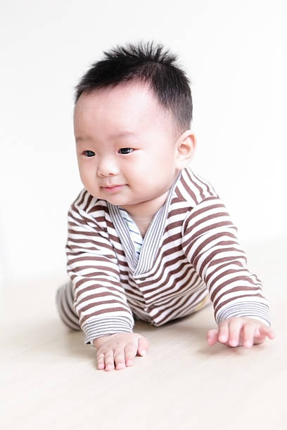 istock Cute Baby crawling on living room floor 486745253