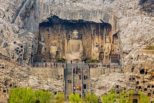 Longmen Grottoes Luoyang,China -MAR 19: Visitors at Longmen grottoes on March 19, 2014.It is one of the four notable grottoes in Luoyang,Henan,China . A UNESCO World Heritage Site. grotto cave photos stock pictures, royalty-free photos & images