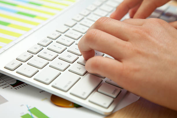 Side view of hands typing stock photo