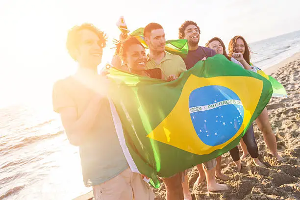 Photo of Group of Friends with Brazilian Flag at Beach