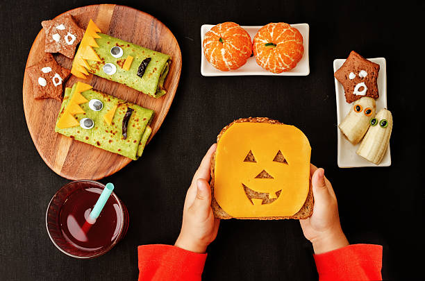 istock childrens hands holding sandwich in the form of monsters 486747032