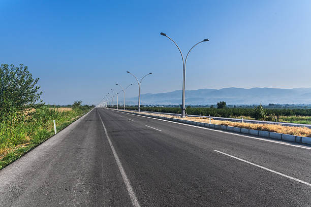 istock Nice country road with blue sky and white clouds background 486747702