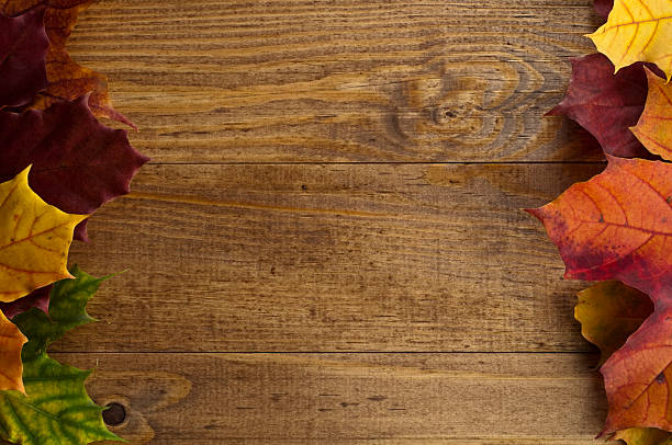 istock Autumn maple leaves on old wooden table. 486748320