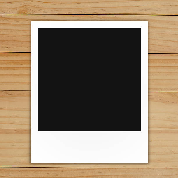 istock blank polaroid photo frame on brown wood plank background 486748971