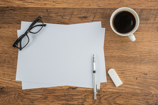 paper, Eraser Ruler glasses and drawing pen with cup of coffee