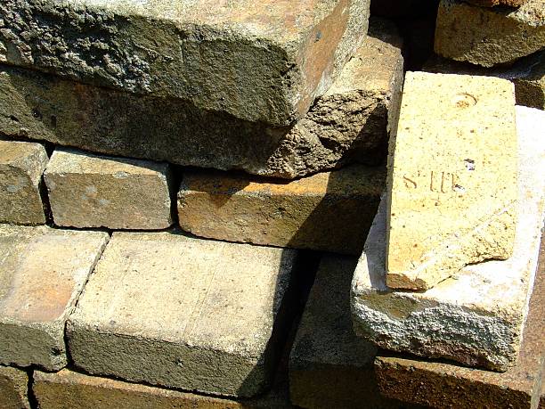 istock Stack of sun lighted old used dusty paver building bricks 486752798