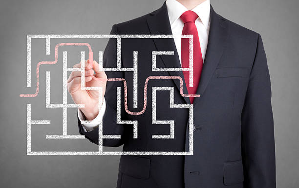 istock Businessman finding the solution of a maze 486754596
