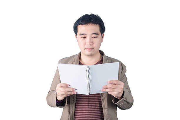 istock Asian businessman holding pen and writing notebook, isolated 486754730