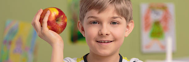 istock Photo of boy with apple 486755502