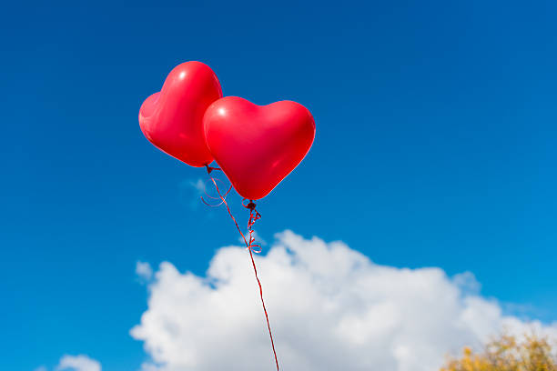 istock Valentine heart balloon against blue sky background 486759116