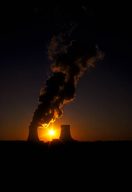 People looking on nuclear power plant cooling tower collapse at sunset in Grafenrheinfeld; Bavaria, Germany - 16.08.2024