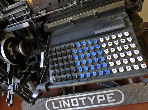 A retro vintage mechanical Linotype machine, resembling a typewriter. Machines like these were used in the printing industry prior to the age of computerized and digital printing.