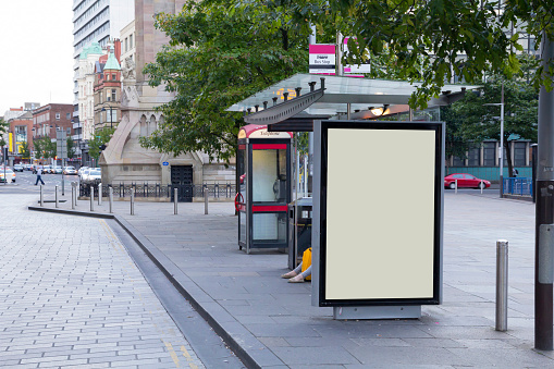 Blank billboard in a bus stop, in urban environment