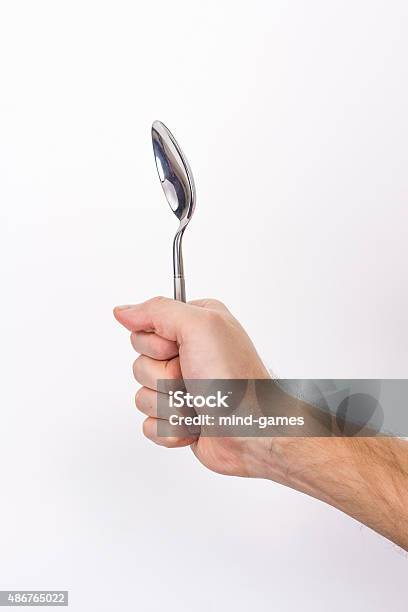 Hand Is Holding A Spoon Isolated Stock Photo - Download Image Now - 2015, Adult, Breakfast