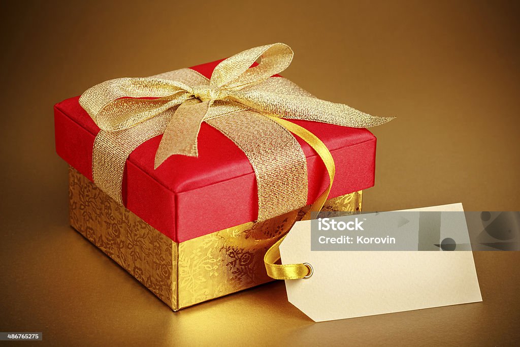 Christmas gift box on gold background Anniversary Stock Photo