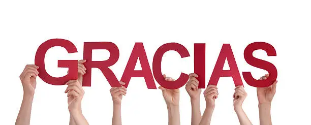 Many People Holding the Spanish Word Gracias, which means Thanks, Isolated
