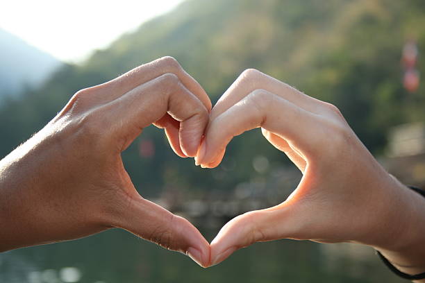 Silhouette of hands in heart shape