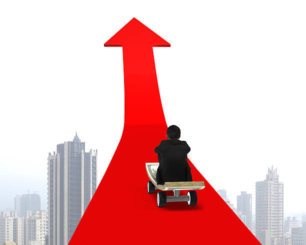 istock Man sitting on skateboard moving toward red arrow 486767901