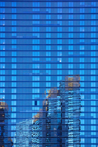 Las Vegas, United States - April 5, 2014: Reflection of the Aria hotel in the Harmon hotel windows in late afternoon with a bright blue sky.