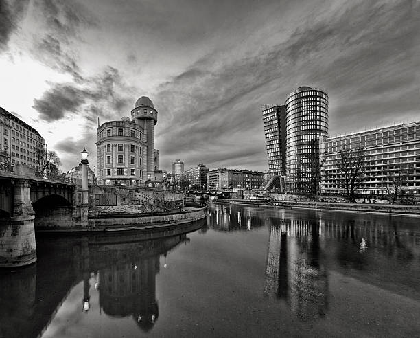 Donaukanal (Danube Canal) of Vienna, Austria. At the right the new UNIQA-Tower and opposite the historic building Urania, a public educational institute and observatory.