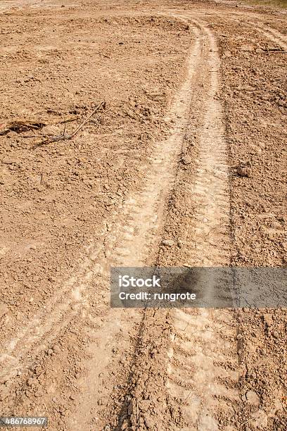 Tractor Tyre Tracks On The Ground Stock Photo - Download Image Now - Abstract, Backgrounds, Brown