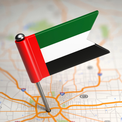Small Flag of United Arab Emirates Sticked in the Map Background with Selective Focus.