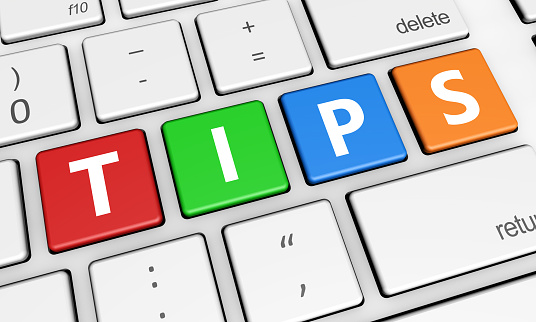 Tips and tricks concept with tips sign and letters on a colorful laptop computer keyboard 3d illustration for blog and online business.