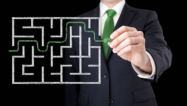 istock Businessman finding the solution of a maze 486774840