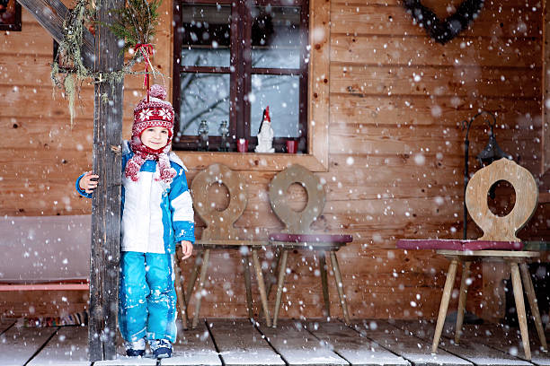 istock Adorable little boy with lantern, standing on a porch 486776062