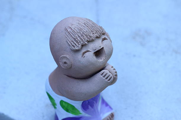 Statue of chinese boy is smiling In the garden background