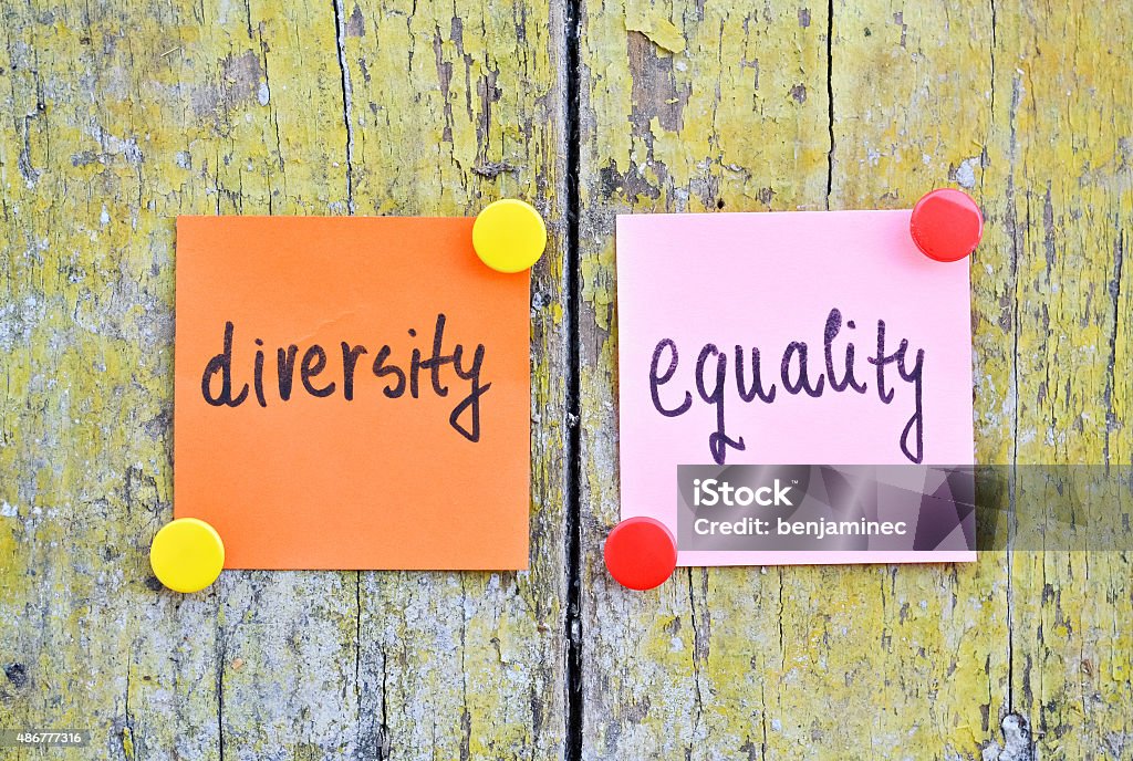 Diversity and Equality Stickers with words Diversity and Equality on wooden background Equality Stock Photo