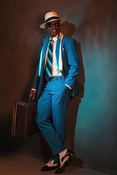 istock African american traveller in blue suit wearing straw hat. 486777514